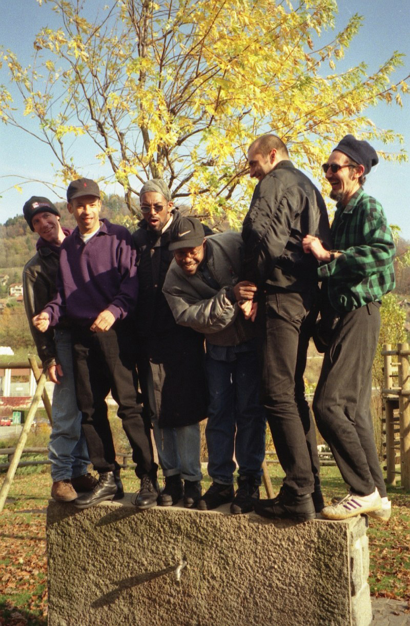Left to right: Bill Smith, Nathan Breedlove, Cutty Williams, Bessa, Jeff Lucas, Claude standing on a rock, playground somewhere at Lac Léman 1996